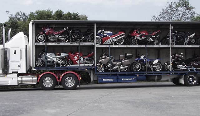 Vehicle transport via open carriers Vehicle transport via open carriers