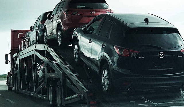 Vehicle transport via open carriers Vehicle transport via open carriers